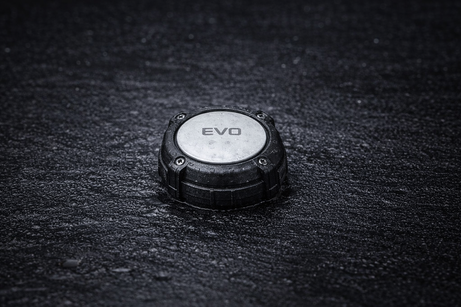 EVO bilge sensor on a dark wet surface — wide product shot